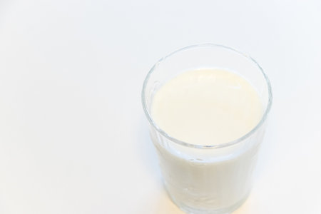 Milk poured into a glassの写真素材