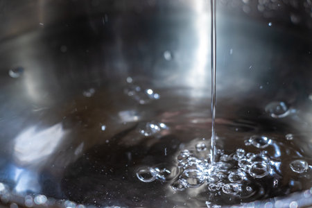 Water flowing down and bubbling on the water surfaceの写真素材