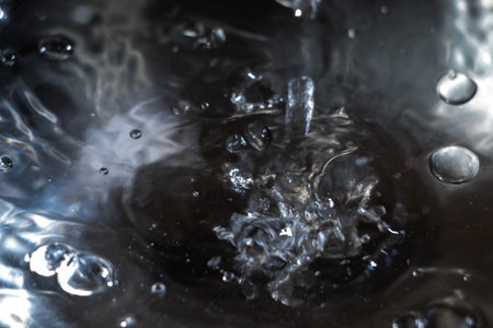 Water flowing down and bubbling on the water surfaceの写真素材