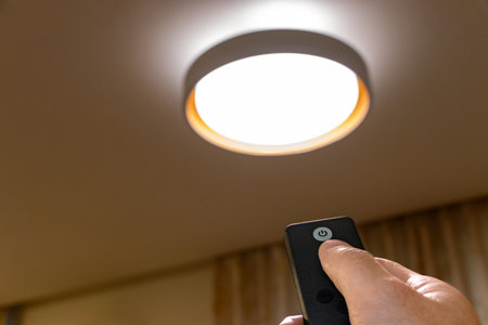 Turn on the ceiling light with the remote controlの写真素材