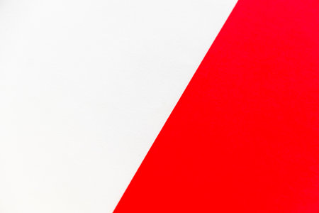 Background material divided into red and white areas by a diagonal boundary lineの写真素材