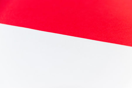 Background material divided into red and white areas by a diagonal boundary line