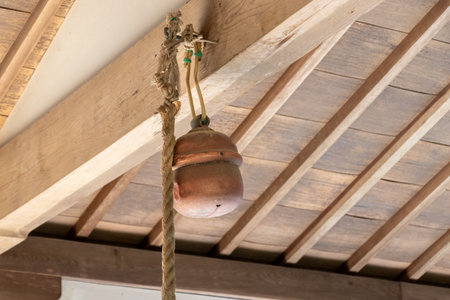 A bell hanging in the main building of a shrineの写真素材