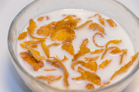Corn flakes soaked in milk in a bowl
