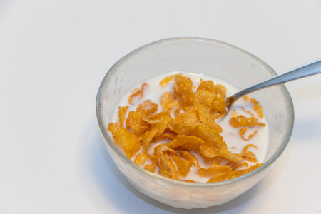 Corn flakes soaked in milk in a bowlの写真素材