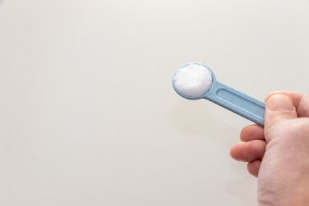 a measuring spoonful of saltの写真素材