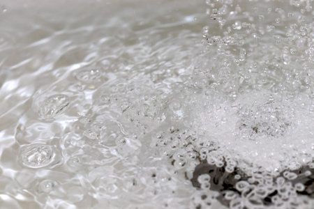 Water splashing down the sink drain