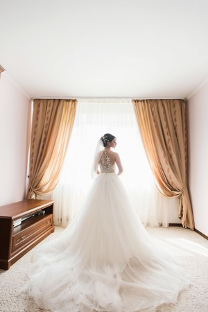 very beautiful morning of a young bride near the windowの写真素材