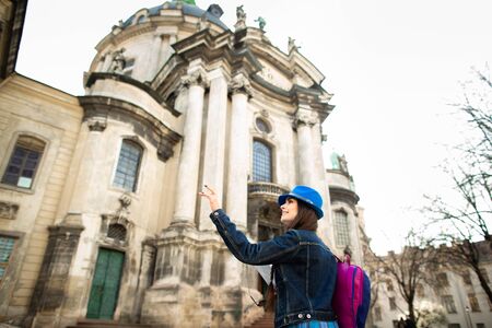 Young woman standing near the church in old city Lviv. Ukraine.の写真素材