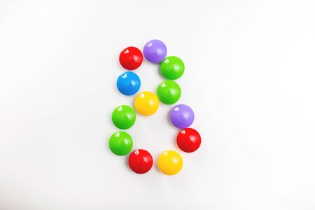 Digit 8 made from children's toys. Multicolored figures for games.