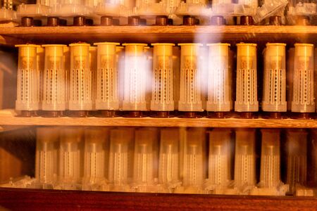 Shelves with cell curlers for the withdrawal of the queen bee in a special locker. Close up, details of beekeeping.の写真素材