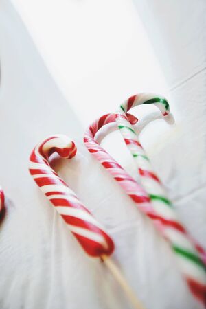 Close up of Christmas striped and colored lollipops. Candies on a white background.の写真素材