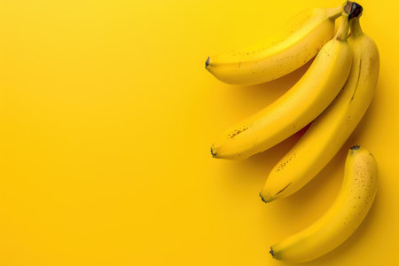 Close up shot of group of bananas on yellow background. Created by aiの写真素材