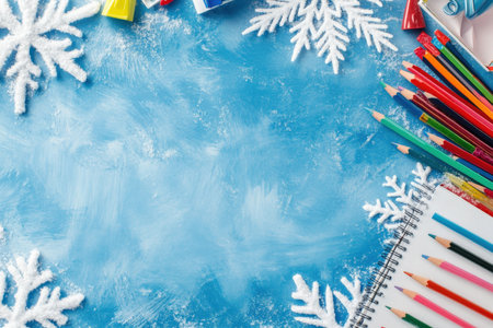 frame of colorful school supplies on winter and snow board background, top view.の写真素材