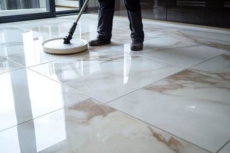 man cleaning and wash tiles floor in apartment. natural window light.の写真素材
