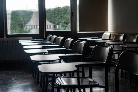 School desks that shine through the windowの写真素材