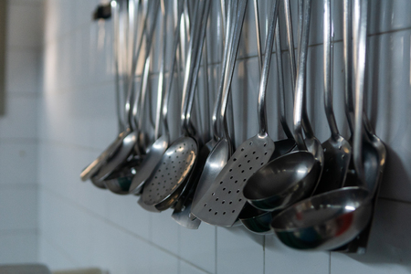 Mass of ron spoons in a restaurant kitchenの写真素材