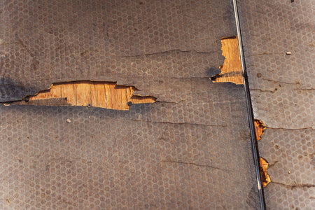 Close up of a carpet with a hole, showing the layers beneathの写真素材