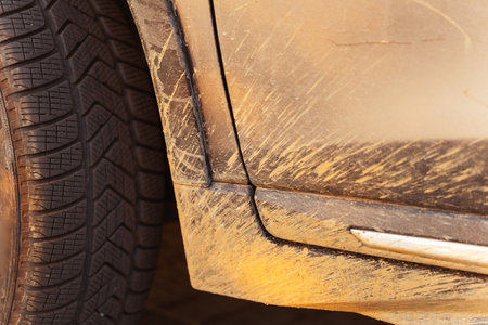 dirt on the front body of a grey car