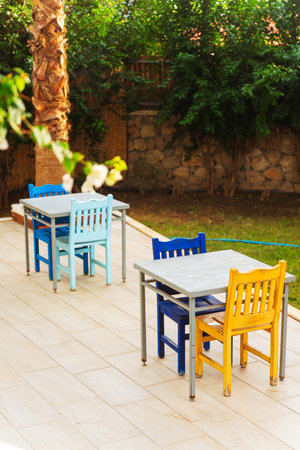 A spacious wooden deck that features tables and chairs arranged on itの写真素材