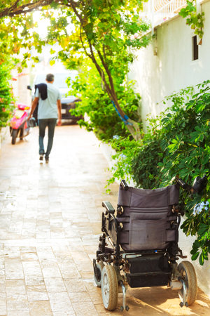 wheelchair parked directly on the garden path.の写真素材