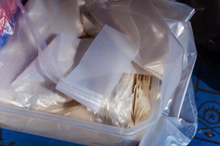 A large plastic container that is filled to the brim with numerous plastic bagsの写真素材