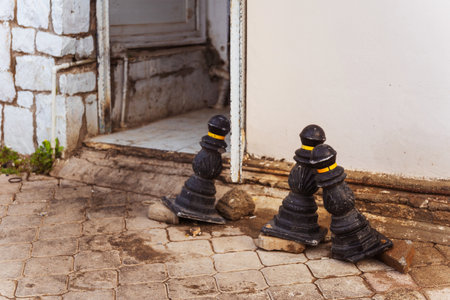 Three destroyed road metal barrier column on the side of paving slabsの写真素材