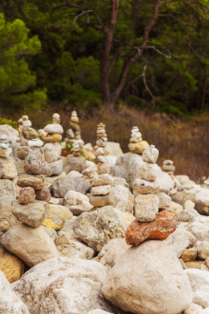 Zen stones neatly arranged stack of rocks surrounded by trees in the background