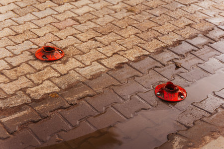 Close up of brick pavement with knocked -down road plastic columnの写真素材