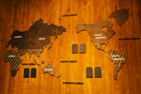 wooden world map on a wooden background. the worlds continents in a smaller version