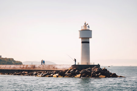 lighthouse on the shore of the bosphorus. embankment in istanbul with a fisherman