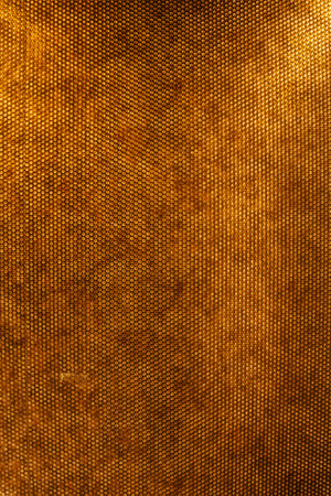 corrugated metal texture. golden texture of iron with holesの写真素材