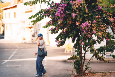 blonde girl in blue pants walking on the street in istanbul. tourist on princes islands in turkeyの写真素材