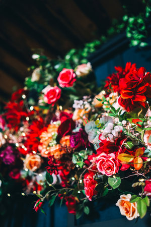 artificial flowers attached to a black lattice. photo zone decoration with flowersの写真素材