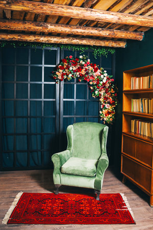 green armchair against of a black lattice decorated with flowers. photo zone with a soft armchairの写真素材