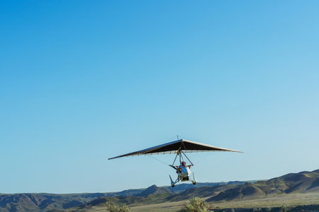 Two-seater hang glider flying in the sky