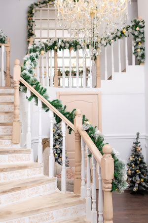wooden staircase in the house decorated with New Years fir branches. Christmas decoration in houseの写真素材