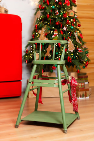 childrens green wooden chair with a Christmas tree. New Years photo zone for a childの写真素材