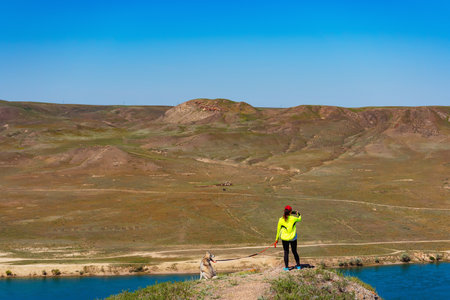 girl with a dog in the mountains. woman with a husky on background of the steppe