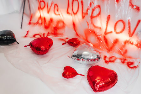foil heart shaped balloons on white floor. photo zone for love day in photo studioの写真素材