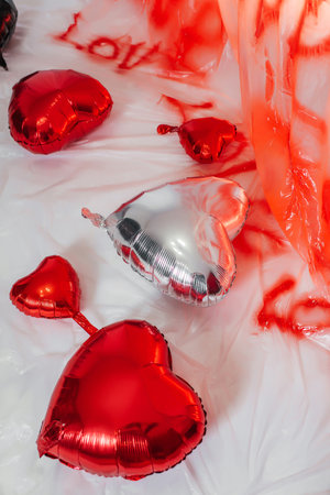 foil heart shaped balloons on white floor. photo zone for love day in photo studioの写真素材