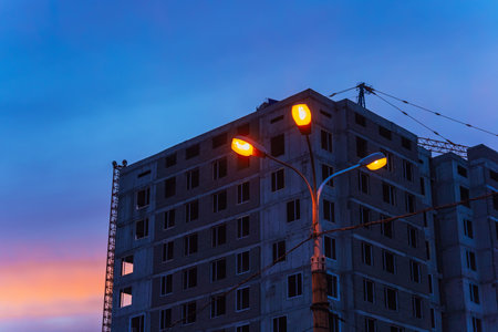 unfinished high-rise building against the backdrop of the sunset sky. building without finishingの写真素材