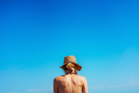 girl in a swimsuit on the shore of Lake Kapchagay. colored swimsuit on a girlの写真素材