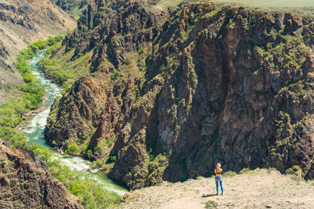 girl against the backdrop of rocky mountains in the Almaty region. rocky plain in Kazakhstanの写真素材