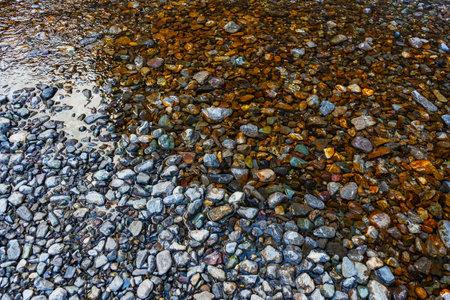 rocky bank of mountain river. river stones textureの写真素材