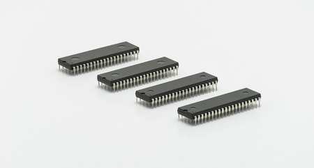 Computer chip DIP 40 pin isolated on white background. Four pieces in a row