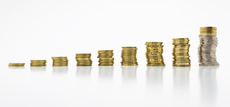 Stack of coins, isolated on white background. Growing and saving money concept.の写真素材
