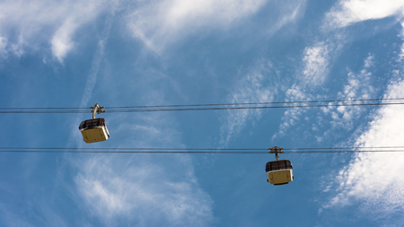 Ropeway with wagons on a background of blue sky with clouds.の写真素材