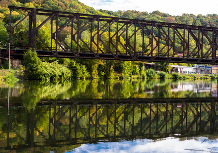 A metal railway bridge over the river.の写真素材