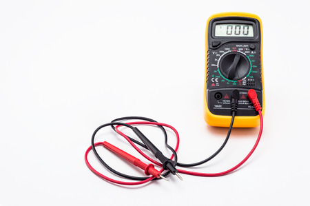 Electric multimeter with red and black probe, display showing zero, with printed circuit board. Isolated on a white background with a clipping path.の写真素材